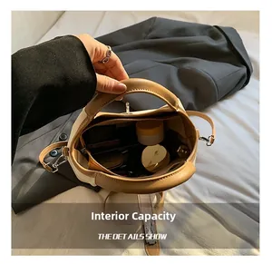 Top view of bucket bag interior capacity showing makeup items and spacious storage