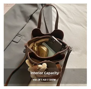 Detail view of large capacity dark brown bucket bag showing internal space and storage