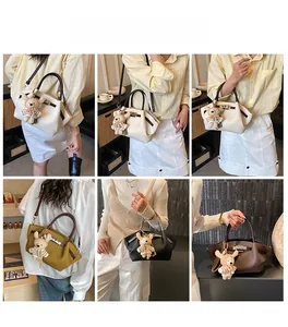 Multiple views of a vintage textured leather handbag with a bear plush charm