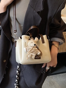 Chic cream contrast handbag with lychee texture and cute bear charm for women