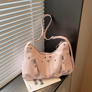 Pink faux leather tote with silver rivets and zippers for a stylish spring look