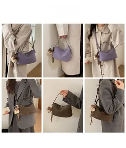 Detail view of purple and brown leather underarm bags with cute bear charm accents