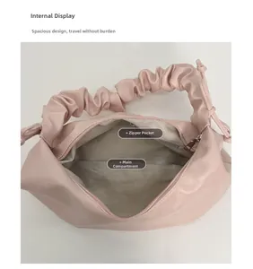 Detail view of pink shoulder bag interior featuring herringbone lining and zipper pocket