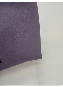Detailed close-up of purple lychee pattern leather bucket bag with silver metal eyelet