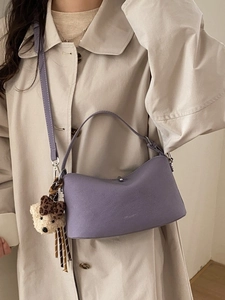Elegant purple leather crossbody bag for women with cute bear charm and shoulder strap