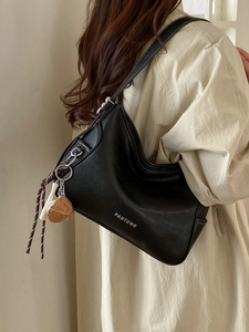Classic black crossbody square bag with contrast stitching and heart pendant detail