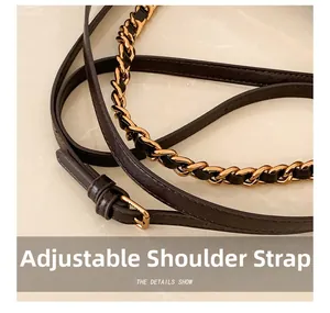 Close-up of adjustable brown leather shoulder strap with gold chain and buckle details