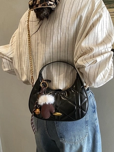 Black quilted crescent handbag with gold chain strap and plush glove charm decoration