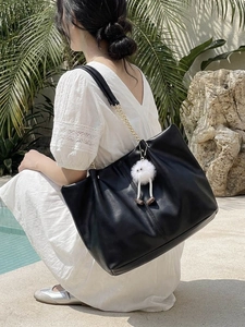 Chic black large-capacity PU leather tote bag with gold chain strap and plush pendant