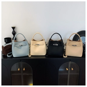 Detailed view of four leather bucket bags in blue, white, black, and apricot colors
