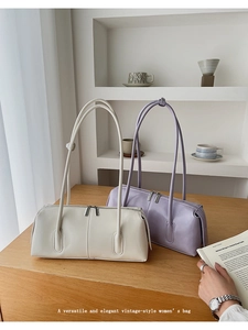 Close-up of minimalist retro tote bags in cream and lavender with silver zippers