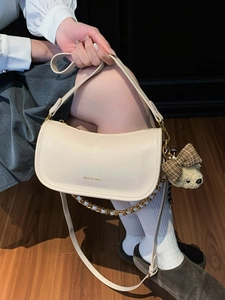 Chic off-white baguette bag with chain strap and teddy bear charm for women