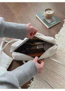 Top-down macro view of white leather tote bag interior showing spacious storage and lining