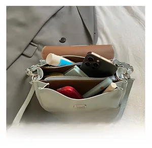 Interior view of mint green handbag showing multiple compartments and large storage capacity