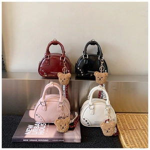 Detailed grid of mini bowling bags in burgundy, black, pink, and white with bear charms
