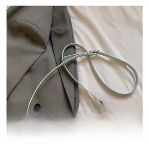 Detail showing the adjustable leather strap and silver chain on mint green handbag