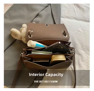 Detail view of the brown leather bag interior showing compartments and storage capacity