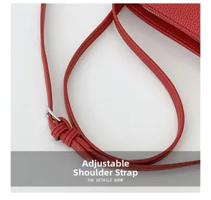 Close-up of the red litchi texture leather strap with silver adjustable buckle detail