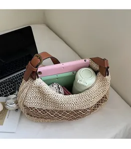 Spacious interior of a woven straw tote bag showing capacity for a tablet and umbrella