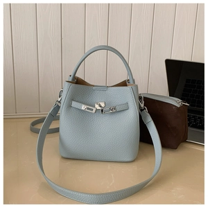 Detail view of light blue lychee pattern bucket bag with silver metal twist lock closure