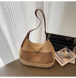 Detail view of woven straw shoulder bag with brown leather strap and wave mesh pattern