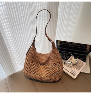 Detailed macro view of brown woven tote bag with leather straps and zip closure