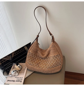 Detail of hand-woven straw shoulder bag with creamy white mesh overlay and leather strap