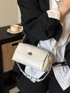 Cream white glossy leather crossbody bag with silver twist lock and chain strap