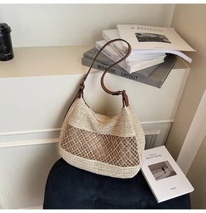 Detail of cream woven shoulder bag with diamond hollow design and brown leather strap