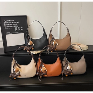 Fünf verschiedene halbmondförmige Ledertaschen in Schwarz, Karamell, Creme, Orange und Taupe