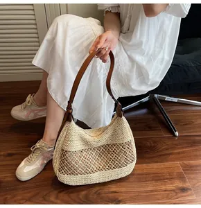 Detailed crochet texture of the beige woven shoulder bag with brown leather strap detail