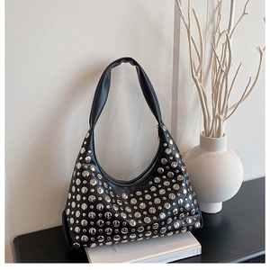 Detaillierte Nahaufnahme einer schwarzen Hobo-Tasche mit silbernen Nieten und Ösen