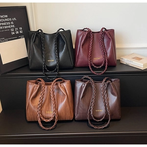 Detail showing woven texture tote bags in black, burgundy, and brown with rope handles