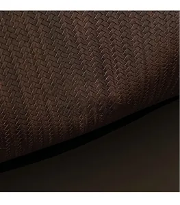 Macro shot of dark brown woven leather texture on a spacious commute tote bag