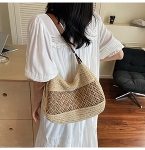 Detail of hollow woven shoulder bag with brown leather straps and beige texture