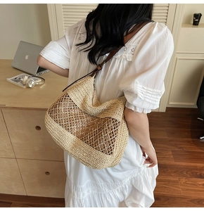 Detail of hand-woven straw tote bag with mesh hollow design and brown leather straps