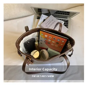 Macro view of the large capacity interior of the brown leather tote bag with zip closure
