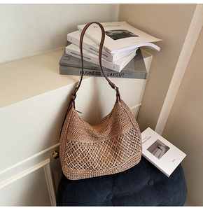 Detailed close-up of retro woven shoulder bag with natural straw texture and brown leather strap