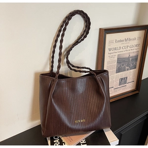 Close-up of vintage dark coffee tote bag with woven texture and braided handle details