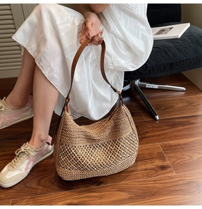 Detail of woven straw shoulder bag featuring mesh knit patterns and leather strap