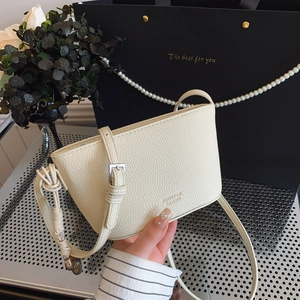 Chic off-white pebble leather mini crossbody bag with knot decor and adjustable strap