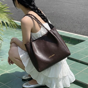 Vintage dark brown woven tote bag with rope handles and golden lettering details