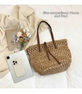 Detail of woven straw tote bag showing large capacity with iPad and phone for size comparison