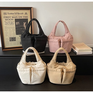 Quilted puffer tote bags in black, pink, cream, and khaki with outer pockets