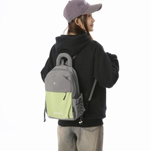Detail view of large capacity gray and neon green backpack with side drawstring pocket
