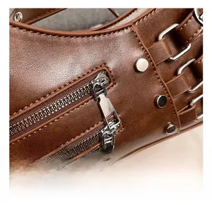 Detailed close-up of premium brown PU leather bag featuring silver zippers and metal rivets