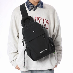 Detail of durable nylon black chest bag with adjustable strap and front zipper compartment
