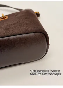Macro detail of brown bucket bag showing thickened PU leather base and gold metal hardware