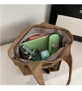 Top view of canvas tote bag showing large capacity, striped lining and zipper closure