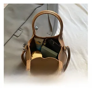 Top view of brown leather bucket bag showing large interior capacity with essentials